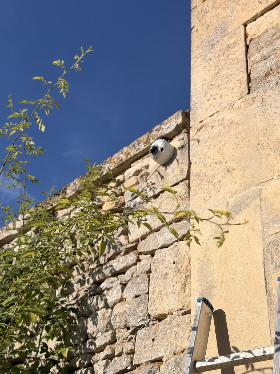 Caméra dôme sur un mur en pierre, contrôlée lors de l'entretien annuel